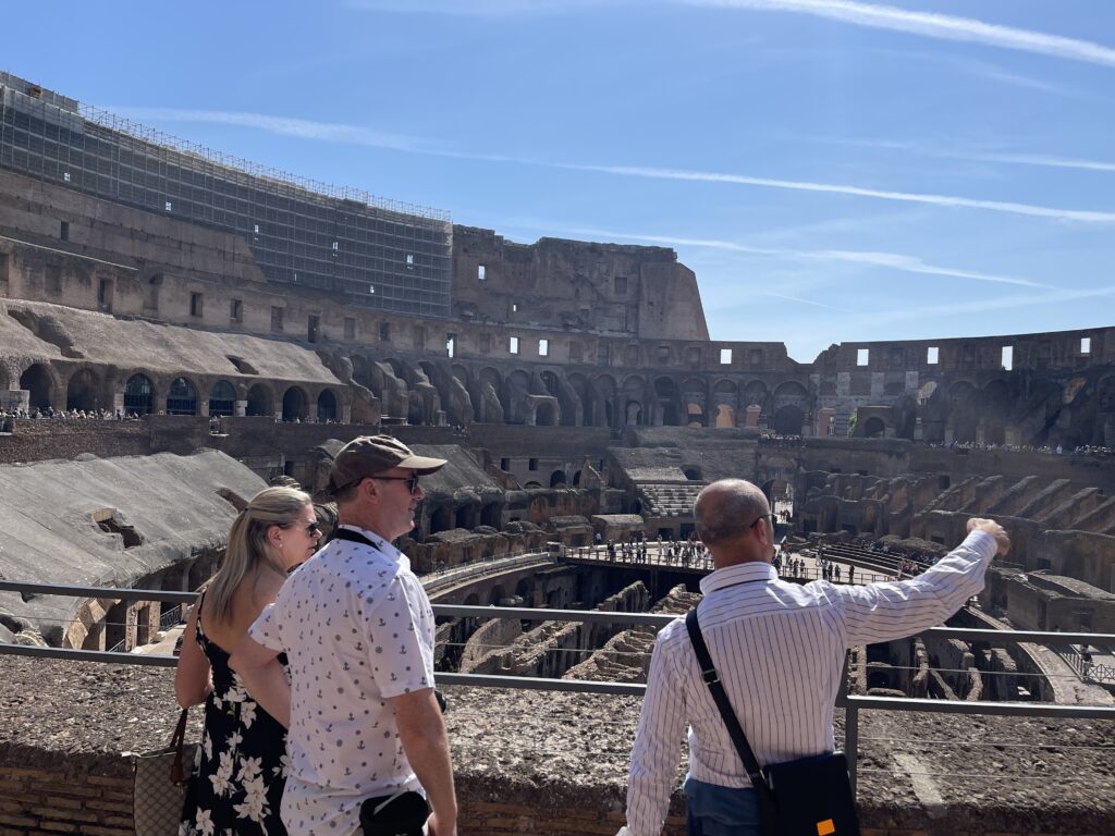 Real Rome Tours guide Max explaining the Colosseum to a couple on our Ancient Rome Tour