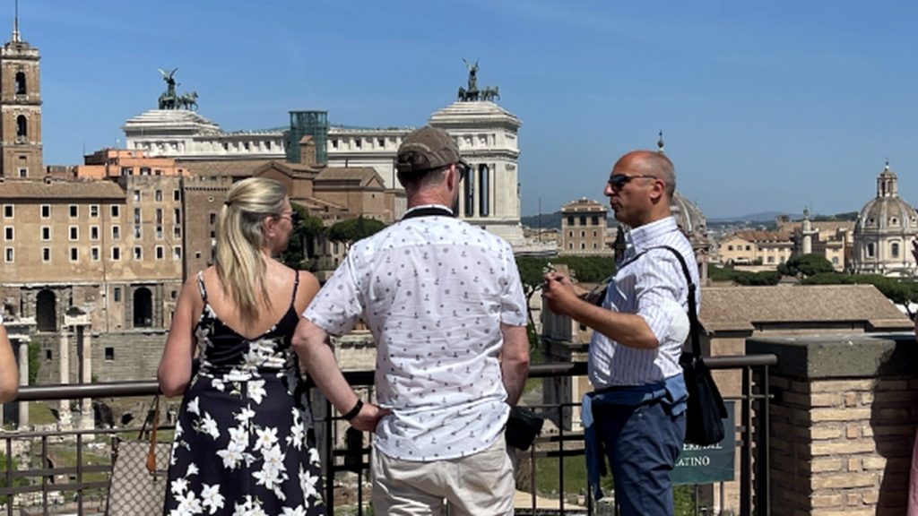 Tour guide Max explaining the Roman Forum to guests from the Palatine Hill